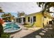 Beautiful backyard features a pool and jacuzzi with an adjacent lounging area at 2487 W Bay Isle Se Dr, St Petersburg, FL 33705