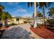 An inviting exterior showcasing the home's curb appeal, featuring a brick paver driveway at 2487 W Bay Isle Se Dr, St Petersburg, FL 33705