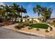 Charming home featuring a well-manicured front yard with a circular driveway and mature palms at 2487 W Bay Isle Se Dr, St Petersburg, FL 33705