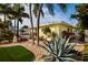 Home featuring lush landscaping, including rocks, palm trees, and agave plants at 2487 W Bay Isle Se Dr, St Petersburg, FL 33705