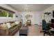 Relaxing living room setup with a neutral color palette, plush seating, and an adjacent desk area at 2487 W Bay Isle Se Dr, St Petersburg, FL 33705
