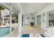 Spacious living room with access to the outdoor pool area through sliding glass doors at 2487 W Bay Isle Se Dr, St Petersburg, FL 33705
