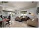 Inviting living room with plush seating, natural light, and access to outdoor space, and a desk area at 2487 W Bay Isle Se Dr, St Petersburg, FL 33705