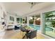Bright living room with pool views through large sliding glass doors and modern furnishings and decor at 2487 W Bay Isle Se Dr, St Petersburg, FL 33705