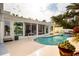 Backyard with beautiful pool and jacuzzi, as seen through glass doors at 2487 W Bay Isle Se Dr, St Petersburg, FL 33705