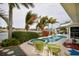 Backyard featuring a pool and hot tub overlooking the water, perfect for relaxing and entertaining at 2487 W Bay Isle Se Dr, St Petersburg, FL 33705