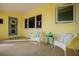 Inviting front porch with cozy seating, creating a warm welcome to this charming home at 2487 W Bay Isle Se Dr, St Petersburg, FL 33705