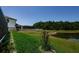 Beautiful backyard with manicured lawn and view of a pond and screened-in pool, great for outdoor living at 2653 Longleaf Pine Pt, New Port Richey, FL 34655