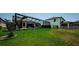 Lush green backyard featuring a screened-in pool and ample space for outdoor activities and relaxation at 2653 Longleaf Pine Pt, New Port Richey, FL 34655
