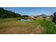Backyard view of the pond and surrounding homes at 2653 Longleaf Pine Pt, New Port Richey, FL 34655
