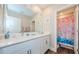 Charming bathroom featuring a dual sink vanity with modern fixtures and a shower with a colorful mermaid curtain at 2653 Longleaf Pine Pt, New Port Richey, FL 34655