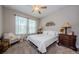 Inviting bedroom featuring a ceiling fan, comfortable armchair, and a bright window at 2653 Longleaf Pine Pt, New Port Richey, FL 34655