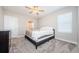 Neutral bedroom with a queen bed, carpet flooring, and windows allowing in natural light at 2653 Longleaf Pine Pt, New Port Richey, FL 34655