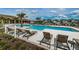 Beautiful community pool with comfortable lounge chairs, shaded areas, and palm trees offering a resort-style experience at 2653 Longleaf Pine Pt, New Port Richey, FL 34655
