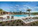 Stunning community pool area with plenty of lounge chairs and umbrellas, perfect for relaxation and socializing at 2653 Longleaf Pine Pt, New Port Richey, FL 34655