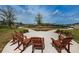Relaxing outdoor space with Adirondack chairs facing community amenities at 2653 Longleaf Pine Pt, New Port Richey, FL 34655
