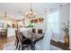 Dining area that opens to kitchen with views and updated lighting at 2653 Longleaf Pine Pt, New Port Richey, FL 34655