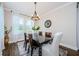 Elegant dining room with a stylish chandelier and large windows for natural light at 2653 Longleaf Pine Pt, New Port Richey, FL 34655