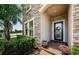 Inviting front entry with stone accents, a decorative wreath, and colorful potted flowers at 2653 Longleaf Pine Pt, New Port Richey, FL 34655