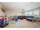 Spacious game room filled with toys, a large sectional sofa, and plenty of natural light at 2653 Longleaf Pine Pt, New Port Richey, FL 34655