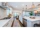 Open kitchen featuring stainless steel appliances, an island with pendant lights, and breakfast nook in view at 2653 Longleaf Pine Pt, New Port Richey, FL 34655
