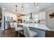 Modern kitchen with stainless steel appliances, a large island, and pendant lighting at 2653 Longleaf Pine Pt, New Port Richey, FL 34655