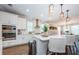 Well-appointed kitchen with double ovens, white cabinets, and a spacious island at 2653 Longleaf Pine Pt, New Port Richey, FL 34655