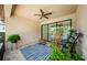 Cozy covered lanai featuring two rocking chairs, ceiling fan, and sliding glass doors overlooking the pool at 2653 Longleaf Pine Pt, New Port Richey, FL 34655