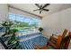 Charming patio with rocking chairs, stylish rug, and potted plants overlooking the pool and serene backyard at 2653 Longleaf Pine Pt, New Port Richey, FL 34655