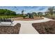 Community playground with a variety of play structures and a bench at 2653 Longleaf Pine Pt, New Port Richey, FL 34655