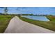 Picturesque pond with a paved walking trail and lush landscaping at 2653 Longleaf Pine Pt, New Port Richey, FL 34655