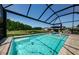 Inviting pool with screened enclosure, and a view of the pond at 2653 Longleaf Pine Pt, New Port Richey, FL 34655