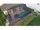 Aerial view of a private screened-in pool, surrounded by a patio, landscaping, and outdoor lounge furniture at 2653 Longleaf Pine Pt, New Port Richey, FL 34655