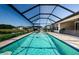 Sparkling swimming pool with a screened enclosure and relaxing lounge area with lake views at 2653 Longleaf Pine Pt, New Port Richey, FL 34655