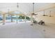 Open-air pool house with ceiling fans, ample seating, and views of the pool at 2653 Longleaf Pine Pt, New Port Richey, FL 34655