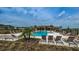 Resort-style pool area with lounge chairs and lush landscaping on a sunny day at 2653 Longleaf Pine Pt, New Port Richey, FL 34655