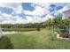 Expansive backyard with a serene lake view and lush green lawn, perfect for outdoor enjoyment at 29542 Forest Glen Dr, Wesley Chapel, FL 33543