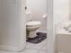 A partial view of a bathroom featuring a toilet and a corner of a bathtub at 29542 Forest Glen Dr, Wesley Chapel, FL 33543
