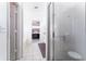 A view of the shower and a portion of the sink area in an all-white bathroom at 29542 Forest Glen Dr, Wesley Chapel, FL 33543