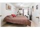 Cozy bedroom featuring a patterned bedspread, ceiling fan and small vanity area at 29542 Forest Glen Dr, Wesley Chapel, FL 33543