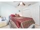 Comfortable bedroom features queen size bed, ceiling fan, side table with lamp, and closet at 29542 Forest Glen Dr, Wesley Chapel, FL 33543