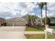 Charming two-story home with a three-car garage, landscaping, and a well-manicured lawn at 29542 Forest Glen Dr, Wesley Chapel, FL 33543