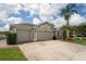 Charming home with a three-car garage and lush landscaping, enhancing its curb appeal at 29542 Forest Glen Dr, Wesley Chapel, FL 33543
