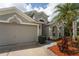 Charming two-story home with a three-car garage, landscaped yard, and well-maintained lawn at 29542 Forest Glen Dr, Wesley Chapel, FL 33543