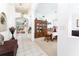 Bright hallway with tiled floors leading to the living area, showcasing an open floor plan and neutral decor at 29542 Forest Glen Dr, Wesley Chapel, FL 33543