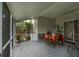Enclosed patio features tile flooring, a ceiling fan, and pond views at 29542 Forest Glen Dr, Wesley Chapel, FL 33543
