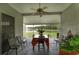 Screened-in patio with a dining table and chairs overlooking a tranquil pond at 29542 Forest Glen Dr, Wesley Chapel, FL 33543