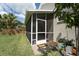 A screened-in porch with a white frame and door provides a relaxing outdoor space at 29542 Forest Glen Dr, Wesley Chapel, FL 33543