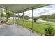 Enjoy the serene lake views from the spacious screened porch with tile flooring at 29542 Forest Glen Dr, Wesley Chapel, FL 33543