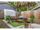 Cozy backyard with patio seating, an outdoor shed, plants, and a fire pit at 3008 N 13Th St, Tampa, FL 33605